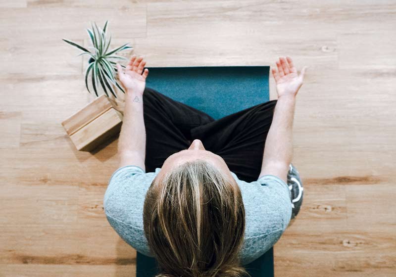 frau meditiert auf yogamatte